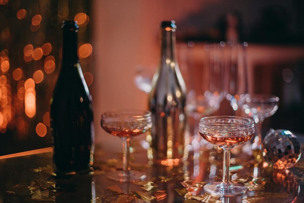 Charming party scene with champagne glasses, bokeh lights, and festive decorations.