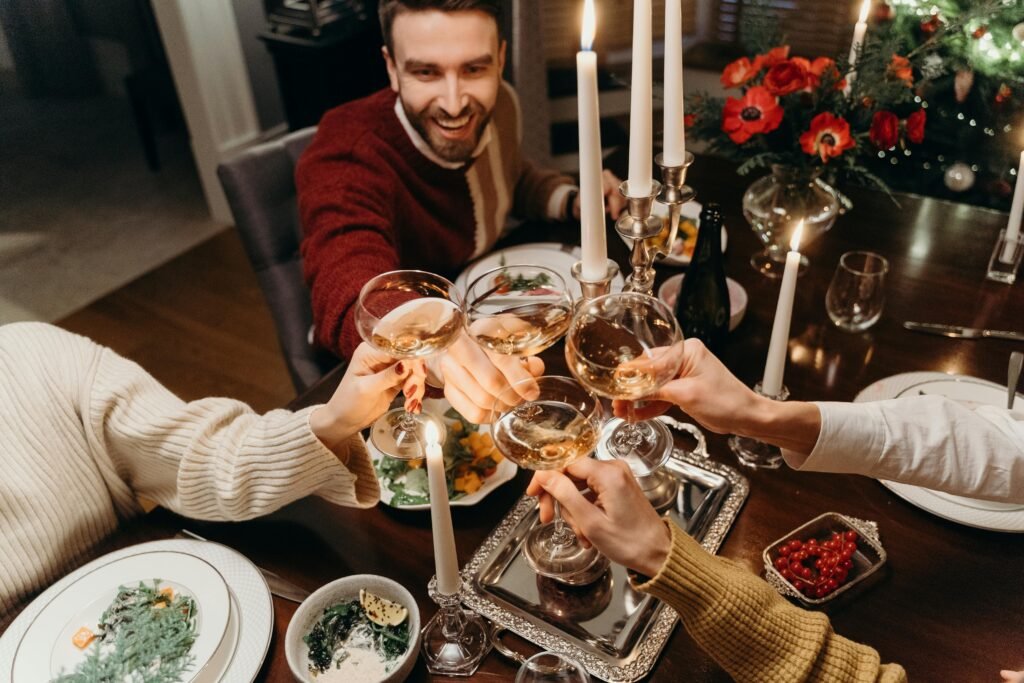 A joyful dinner party featuring friends clinking champagne glasses in celebration.
